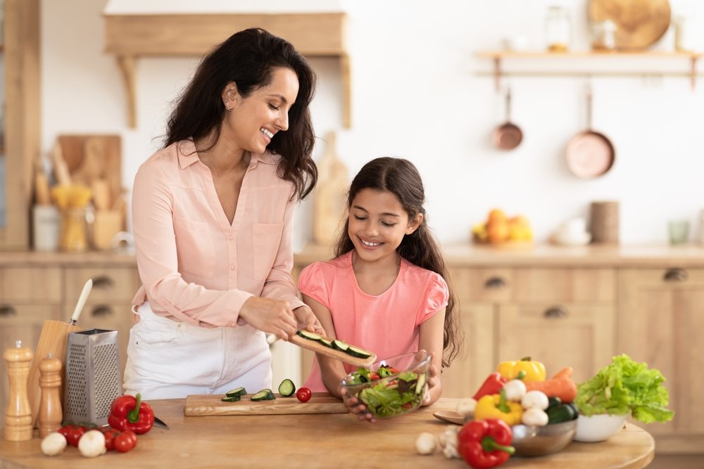 Cheerful,Mom,And,Daughter,Kid,Joyfully,Making,Salad,From,Fresh